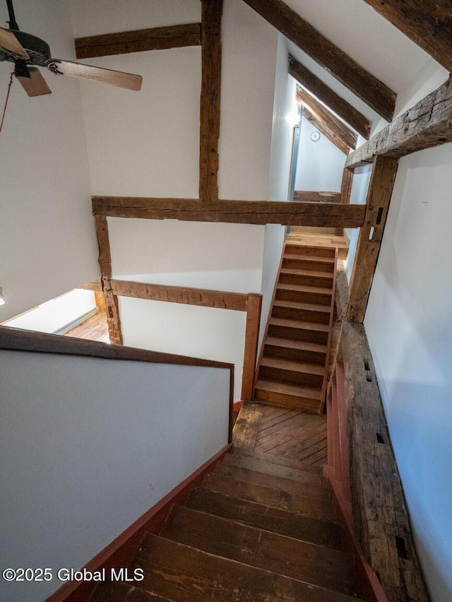 stairs featuring ceiling fan, vaulted ceiling with beams, and hardwood / wood-style flooring