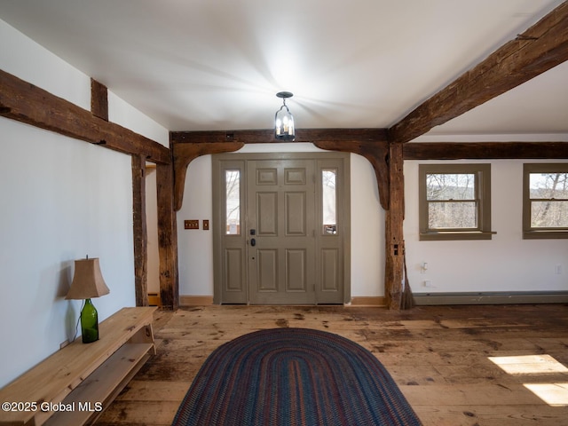 entrance foyer featuring wood-type flooring, beamed ceiling, arched walkways, and baseboards