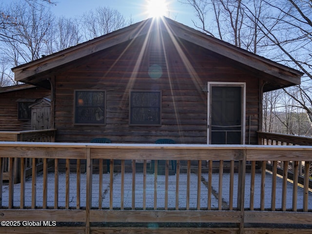 rear view of property with a deck with water view