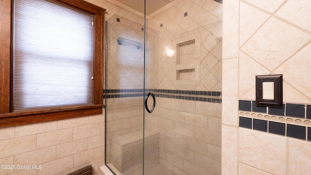 bathroom featuring crown molding, plenty of natural light, and a stall shower