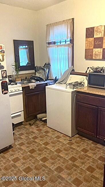 2373 Burdett Ave, Troy, NY 12180 - washroom featuring a sink, brick patterned floor, and washer / dryer