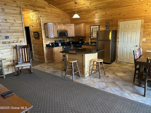 3210 Lake Shore Dr # 34Interval 5, Lake George, NY 12845 - kitchen featuring wood walls, stainless steel appliances, vaulted ceiling, a sink, and a kitchen bar