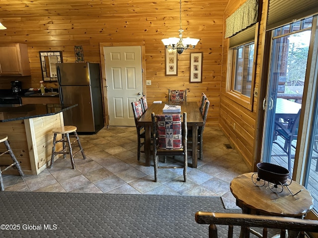 3210 Lake Shore Dr # 34Interval 5, Lake George, NY 12845 - dining space with a chandelier, wooden walls, and stone finish flooring