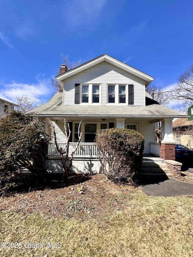 11 Middlesex Rd, East Greenbush, NY 12061 - country-style home with a porch, roof with shingles, and a chimney