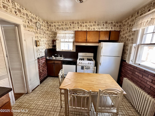11 Middlesex Rd, East Greenbush, NY 12061 - kitchen featuring a sink, under cabinet range hood, white appliances, radiator, and brick floor