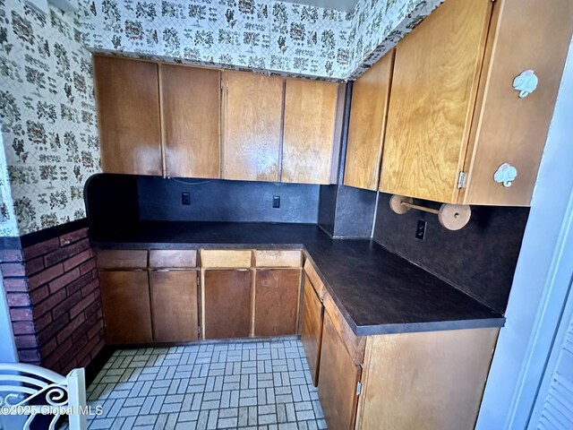 11 Middlesex Rd, East Greenbush, NY 12061 - kitchen featuring dark countertops and wallpapered walls