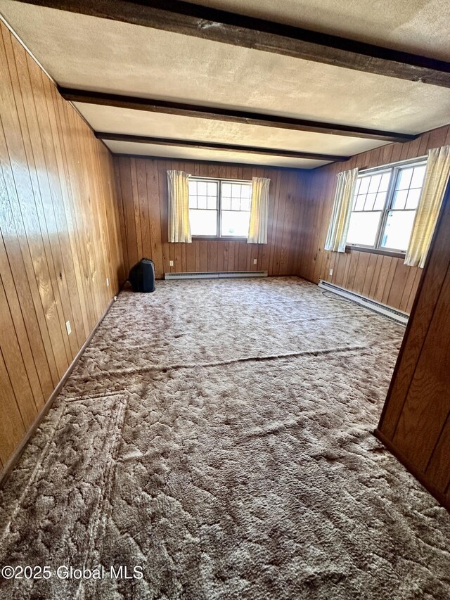 11 Middlesex Rd, East Greenbush, NY 12061 - empty room featuring a baseboard heating unit, beam ceiling, carpet floors, and a textured ceiling