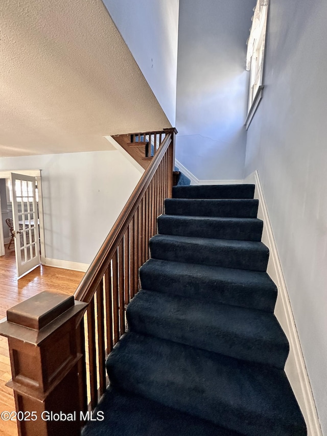 11 Middlesex Rd, East Greenbush, NY 12061 - stairs with wood finished floors, baseboards, and a textured ceiling
