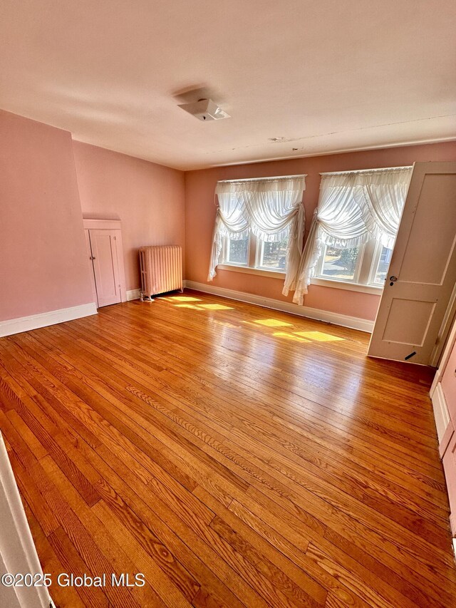 11 Middlesex Rd, East Greenbush, NY 12061 - spare room featuring radiator heating unit, baseboards, and wood finished floors