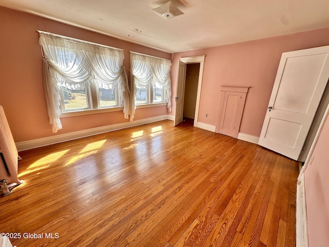 11 Middlesex Rd, East Greenbush, NY 12061 - unfurnished bedroom featuring light wood finished floors, radiator, a closet, and baseboards
