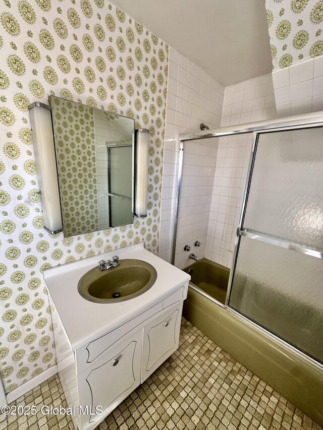 11 Middlesex Rd, East Greenbush, NY 12061 - bathroom featuring wallpapered walls, vanity, tile patterned flooring, and shower / bath combination with glass door