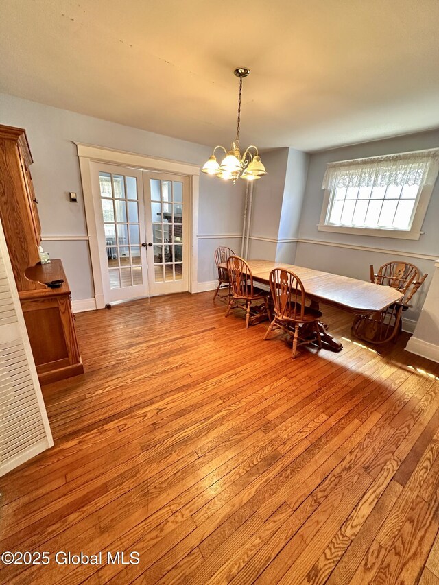 11 Middlesex Rd, East Greenbush, NY 12061 - dining area featuring an inviting chandelier, hardwood / wood-style flooring, french doors, and baseboards