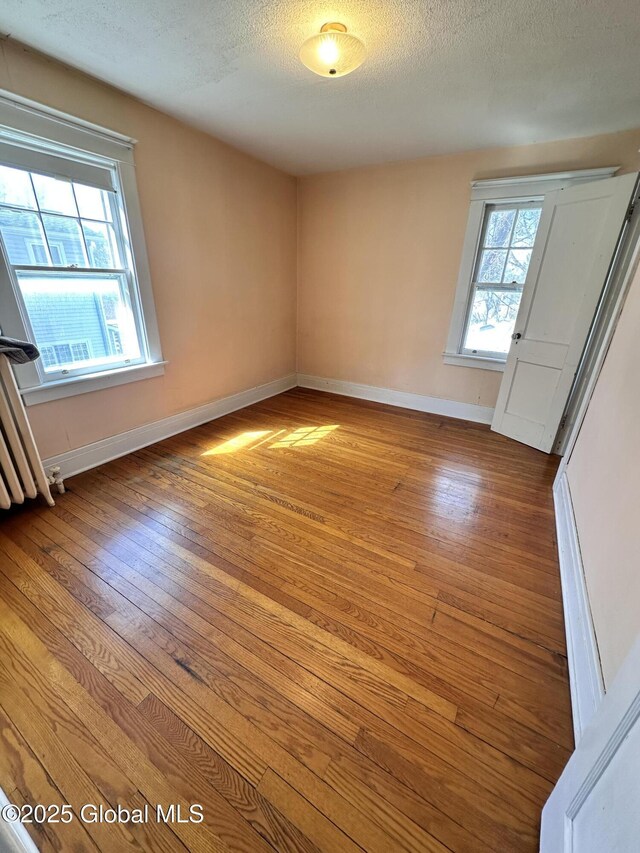 11 Middlesex Rd, East Greenbush, NY 12061 - unfurnished bedroom with a textured ceiling, baseboards, and hardwood / wood-style flooring