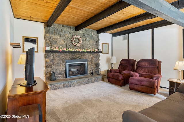 carpeted living area with wood ceiling, beam ceiling, and a stone fireplace
