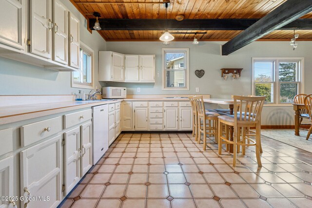 kitchen featuring wood ceiling, white appliances, white cabinetry, light countertops, and beam ceiling