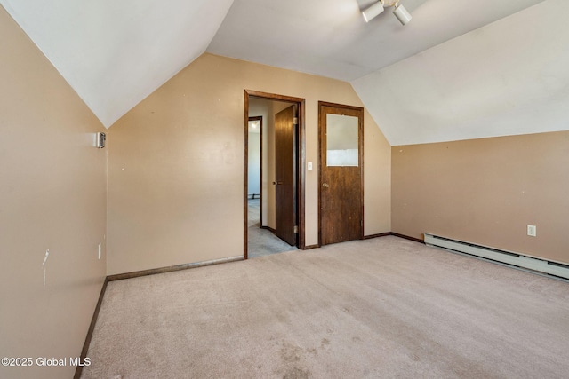 additional living space with vaulted ceiling, carpet, baseboard heating, and baseboards
