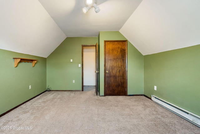 bonus room with baseboard heating, vaulted ceiling, carpet floors, and baseboards