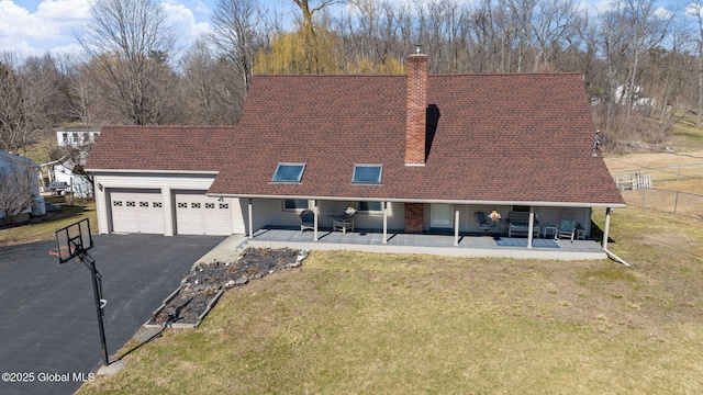 view of front of home featuring an attached garage, a chimney, asphalt driveway, covered porch, and roof with shingles