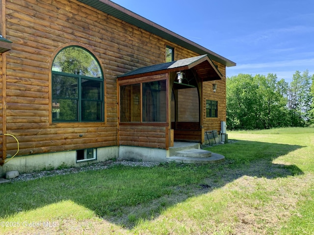 2158 Coach Rd, Argyle, NY 12809 - view of home's exterior featuring a lawn and a sunroom