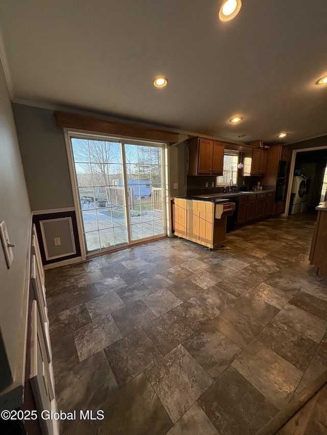 kitchen with refrigerator, ornamental molding, recessed lighting, dark countertops, and stone tile flooring