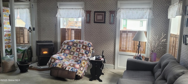 755 County Route 7, Schodack, NY 12063 - living area with baseboards, carpet, a wood stove, and wallpapered walls