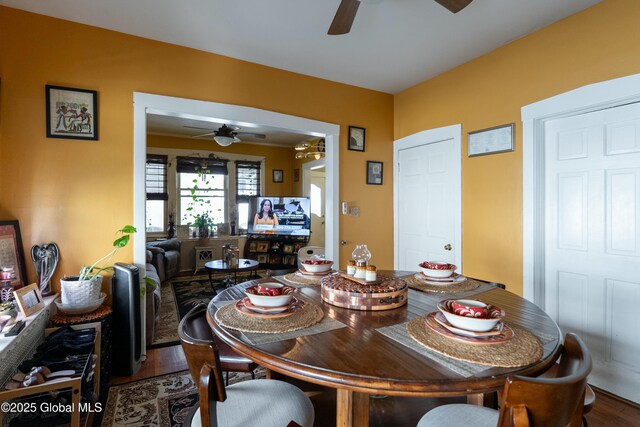 dining room featuring a ceiling fan and wood finished floors