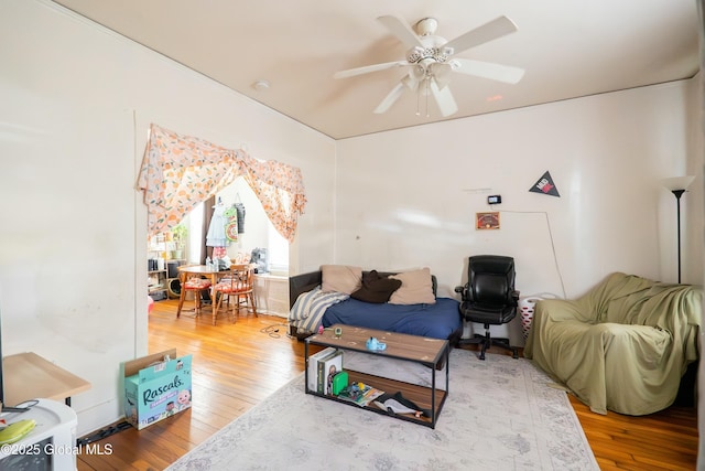 living room featuring a ceiling fan and hardwood / wood-style floors