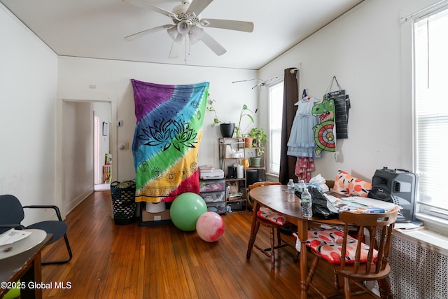 dining room with hardwood / wood-style floors and a ceiling fan