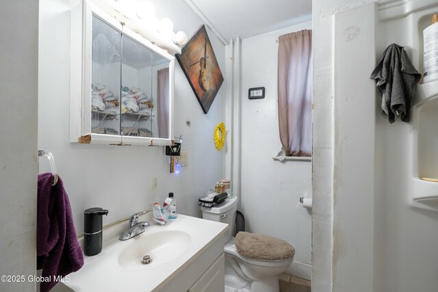 bathroom featuring toilet and vanity