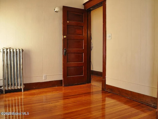 698 State St, Albany, NY 12203 - unfurnished room featuring radiator heating unit, wood finished floors, and baseboards