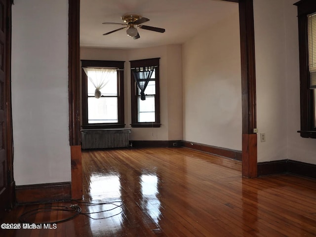 698 State St, Albany, NY 12203 - empty room featuring baseboards, radiator heating unit, a ceiling fan, and wood-type flooring