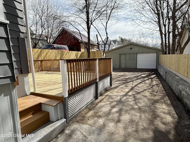 9 Brandt Pl, Amsterdam, NY 12010 - wooden terrace with a detached garage, an outbuilding, driveway, and fence