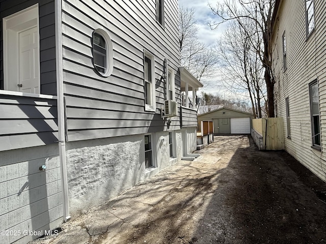 9 Brandt Pl, Amsterdam, NY 12010 - view of property exterior featuring cooling unit, a detached garage, and an outdoor structure