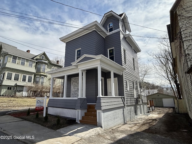 9 Brandt Pl, Amsterdam, NY 12010 - view of front of house with a detached garage, a porch, and an outdoor structure