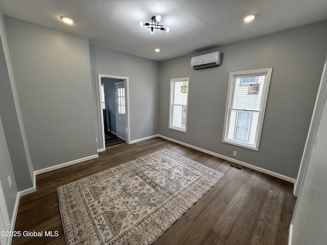 9 Brandt Pl, Amsterdam, NY 12010 - unfurnished room with visible vents, dark wood-type flooring, a wall mounted AC, recessed lighting, and baseboards