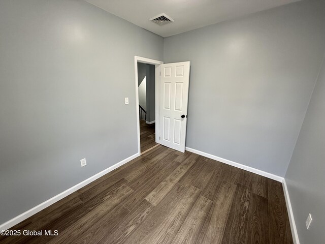 9 Brandt Pl, Amsterdam, NY 12010 - unfurnished room featuring dark wood-style floors, visible vents, and baseboards