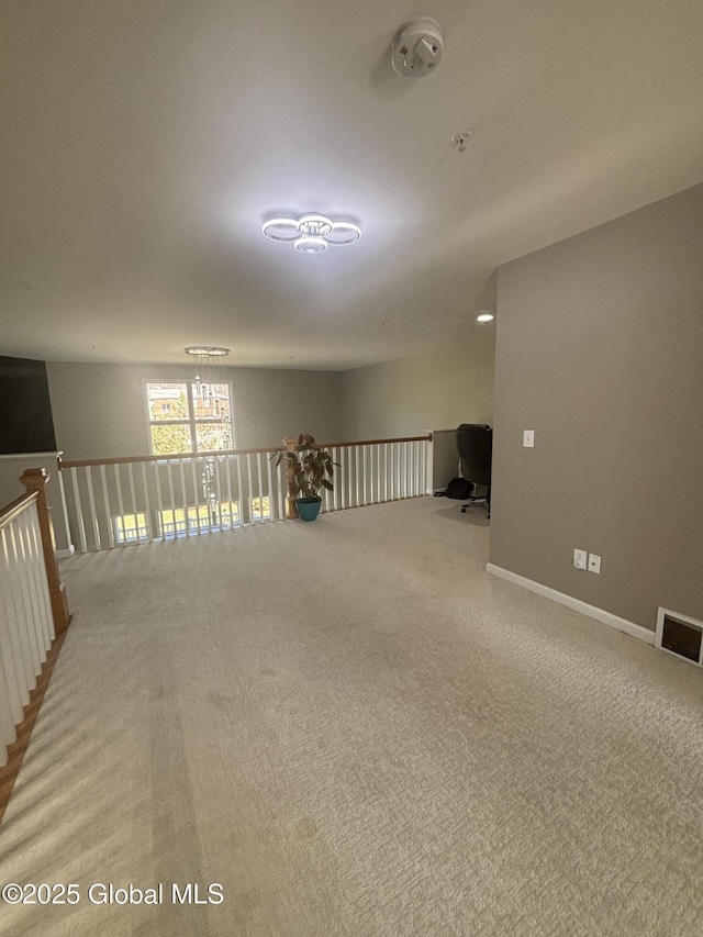 empty room featuring visible vents and carpet floors