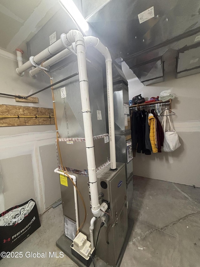 utility room featuring heating unit