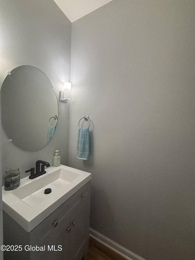 bathroom with vanity and baseboards