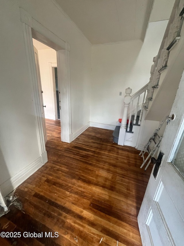 interior space with stairway, wood finished floors, and baseboards