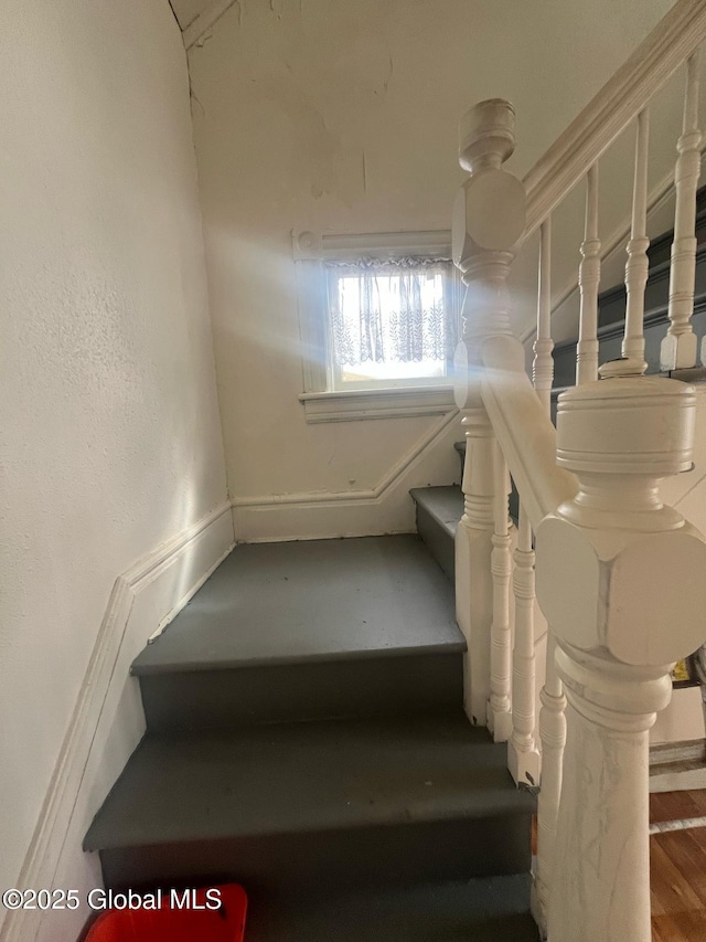 stairs featuring wood finished floors