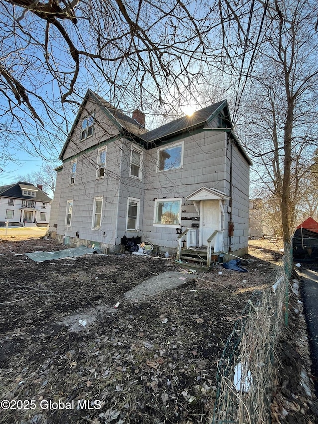 back of property featuring a chimney