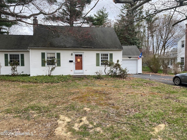 119 Orchard St, Bethlehem, NY 12054 - cape cod house featuring a garage, a chimney, a shingled roof, and aphalt driveway