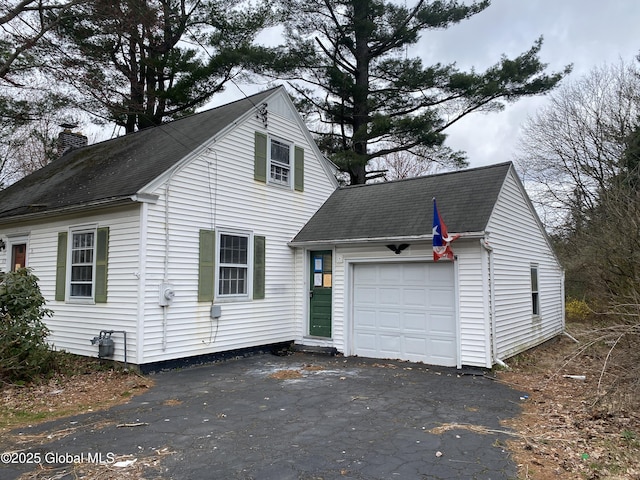 119 Orchard St, Bethlehem, NY 12054 - view of front facade featuring a shingled roof, an attached garage, a chimney, and aphalt driveway