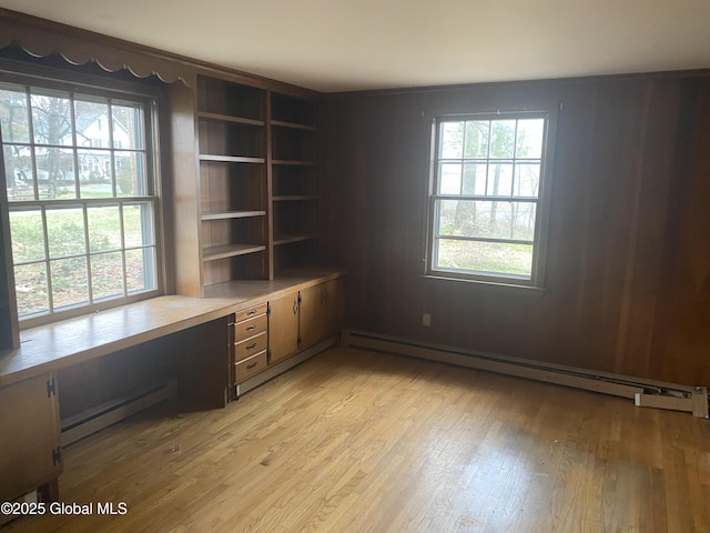 119 Orchard St, Bethlehem, NY 12054 - unfurnished office with a baseboard radiator, light wood finished floors, built in desk, and a baseboard heating unit