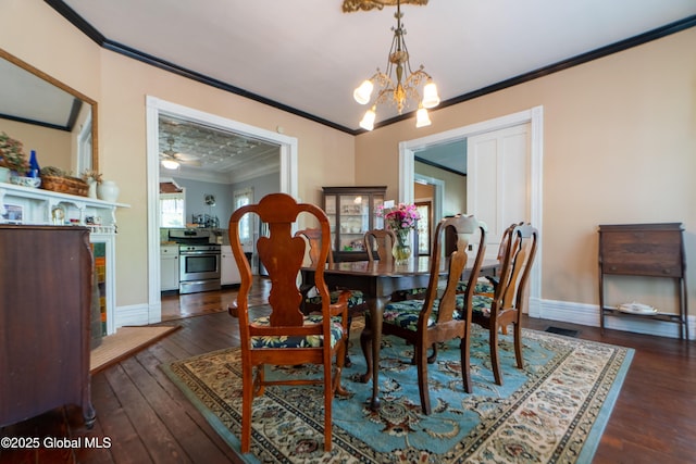 14 Pleasant St, Ballston Spa, NY 12020 - dining room with ornamental molding, a chandelier, dark wood-type flooring, and baseboards