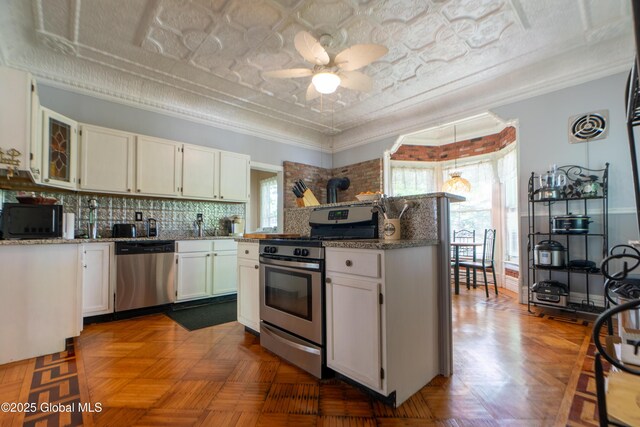 14 Pleasant St, Ballston Spa, NY 12020 - kitchen with appliances with stainless steel finishes, white cabinetry, ceiling fan, an ornate ceiling, and tasteful backsplash
