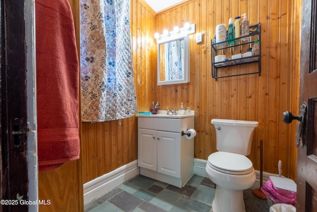 14 Pleasant St, Ballston Spa, NY 12020 - half bathroom featuring vanity, wooden walls, toilet, and baseboards