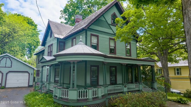14 Pleasant St, Ballston Spa, NY 12020 - victorian-style house with covered porch, an outdoor structure, a garage, and a chimney