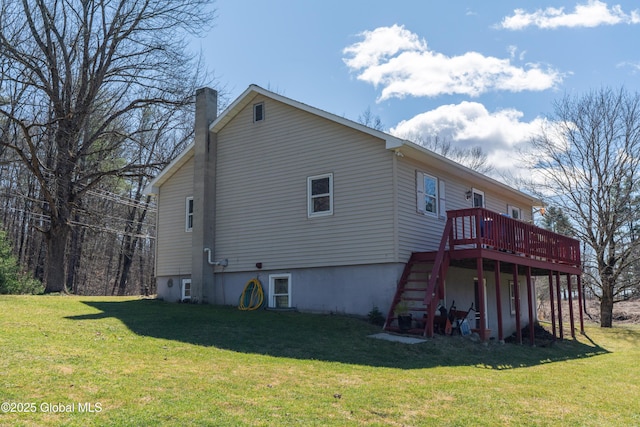 rear view of house with a deck, stairway, a yard, and a chimney